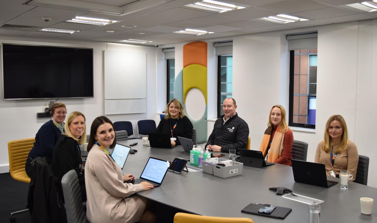 seven manchester central staff sitting in meeting room