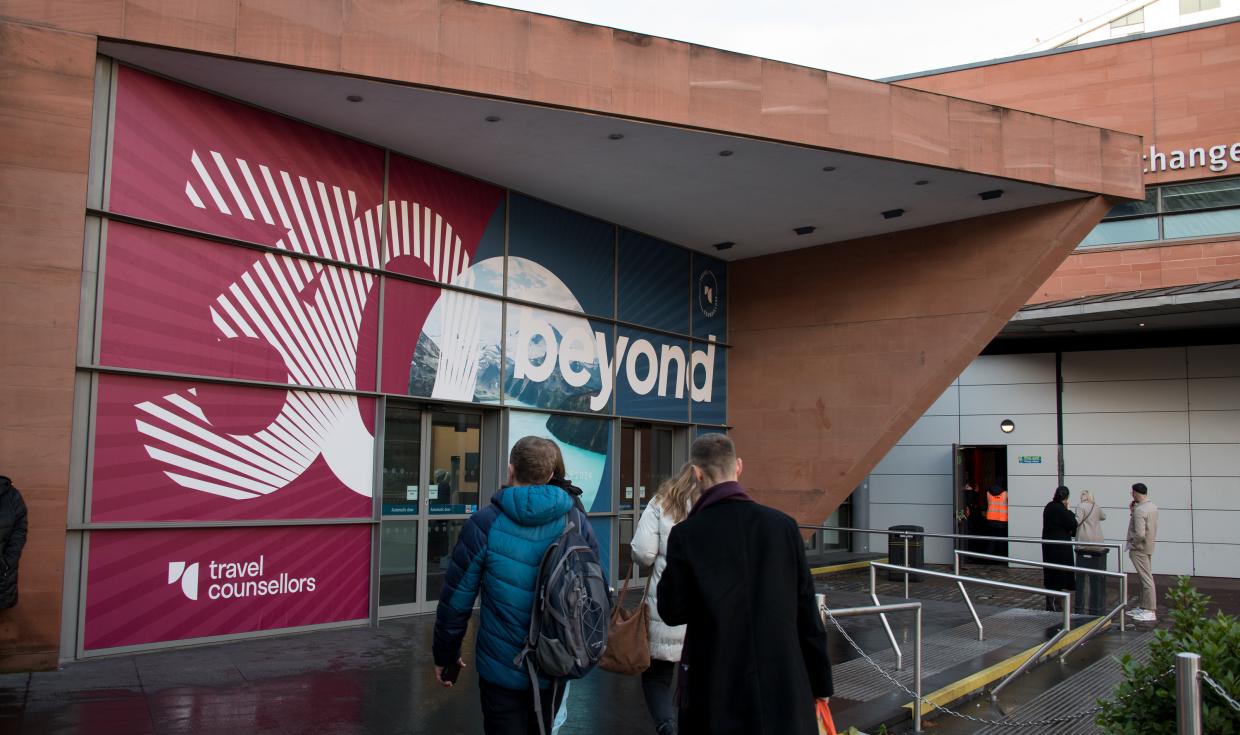 Delegates arriving at the Charter Entrance, branded by the Travel Counsellors and reading '30 beyond'