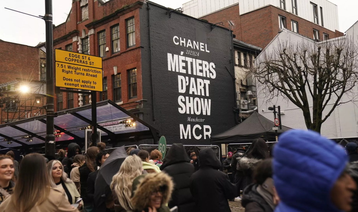 Painted Chanel mural, spelling out Metiers d'art Show MCR, on a wall in the Northern Quarter of Mancheter.